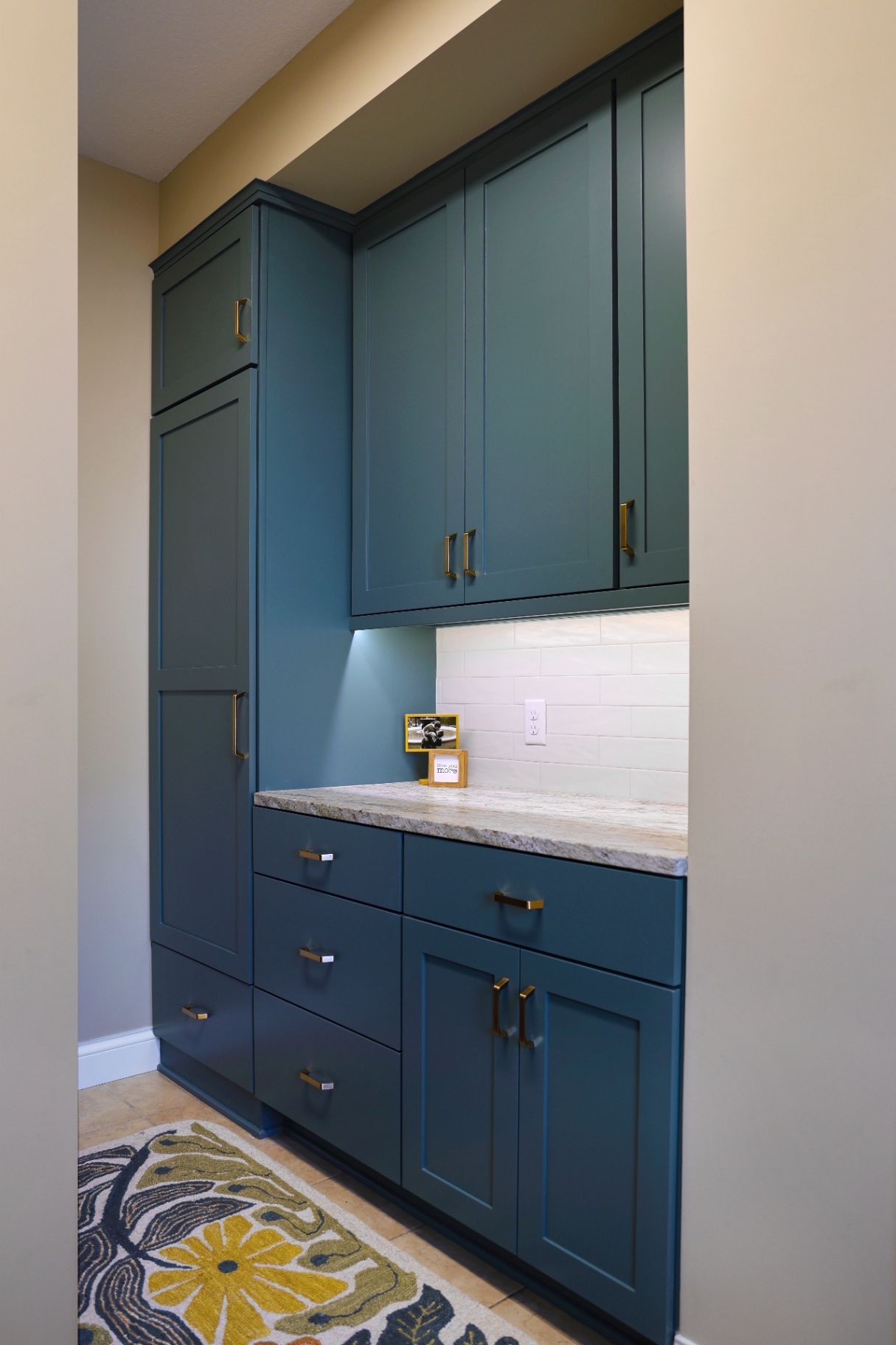 Armatage mudroom in deep teal with brass hardware