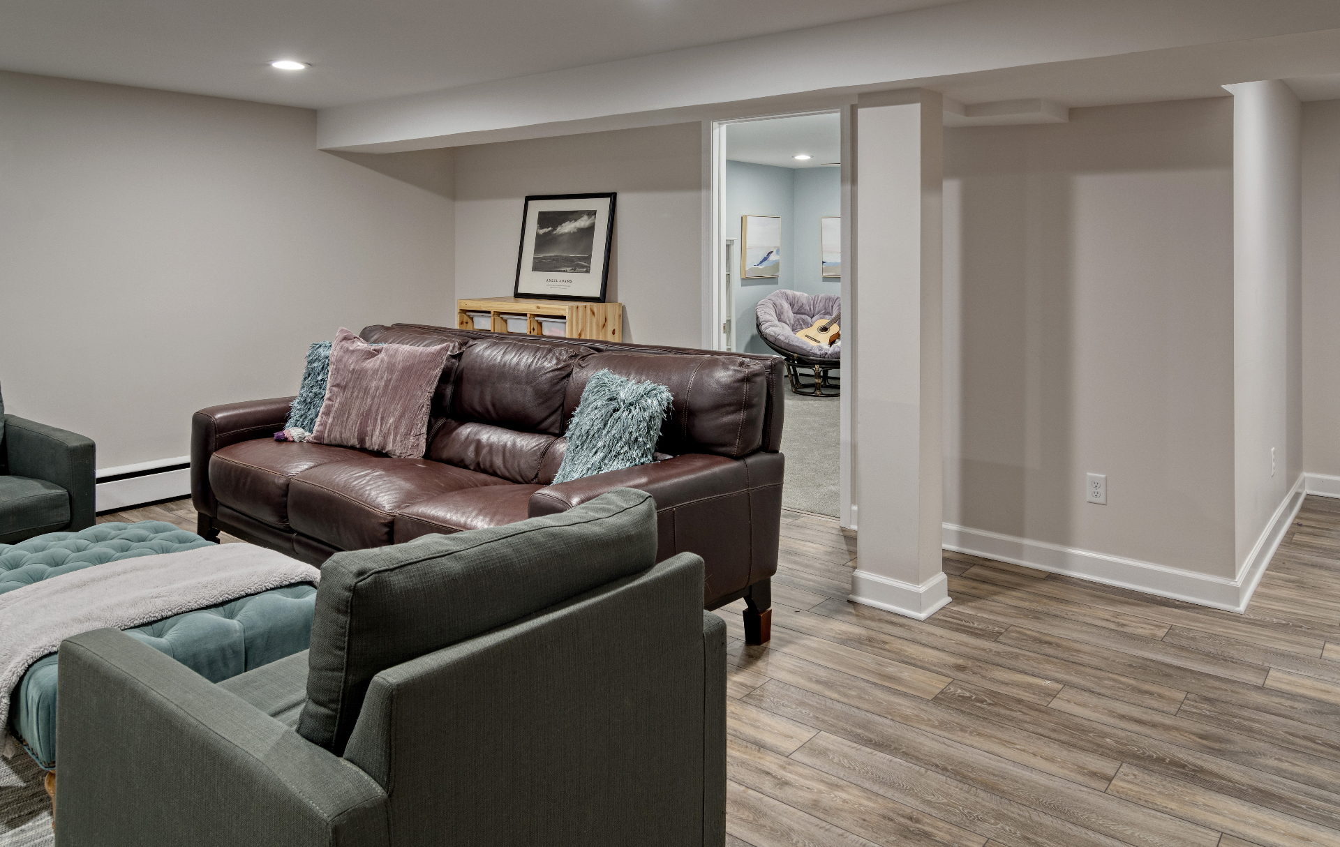 Finished lower level lounge with warm neutral palette