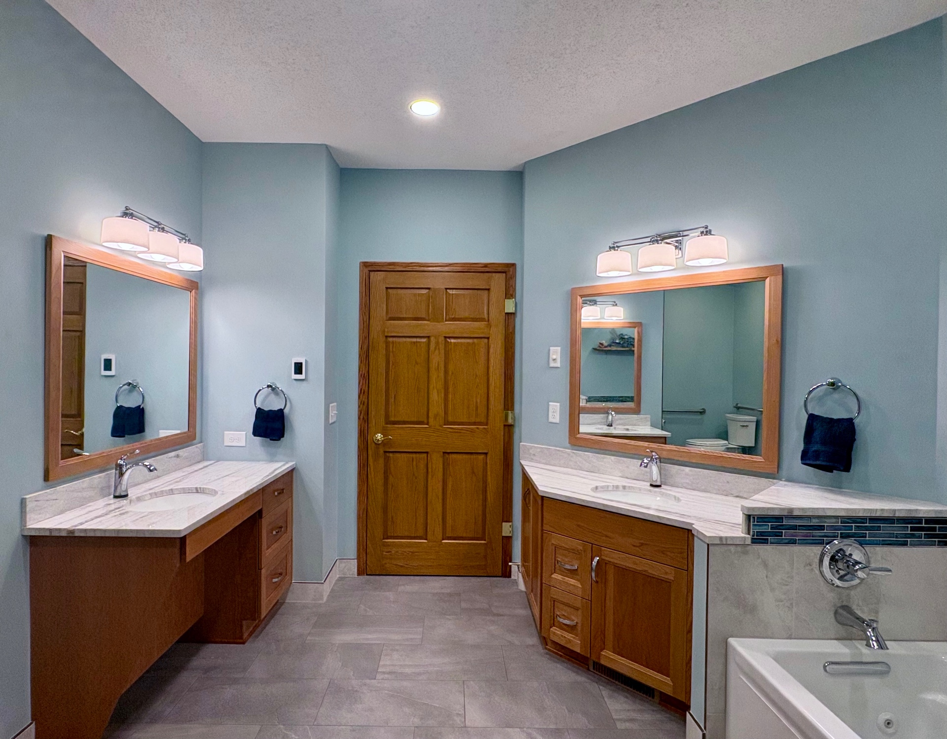 Oak Marsh accessible bathroom with dual roll under vanities